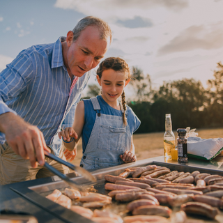man and child at grill