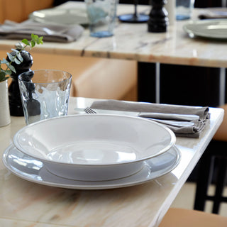 White Costa Nova Friso dinner plate, 11-inch ceramic dish with smooth, glossy finish and simple design for elegant table setting.