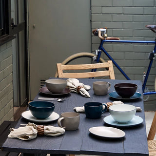 Stacked Costa Nova Stacked Organic Salad and Dessert Plates with salt, featuring a modern, layered design in earthy tones.