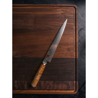 Miyabi Birchwood SG2 9-inch slicing and carving knife with a sharp blade and elegant wooden handle for precise kitchen prep.