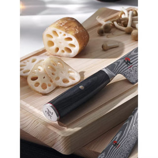 Miyabi Kaizen II 4.5-inch paring knife with sharp stainless steel blade and ergonomic handle for precise kitchen prep.