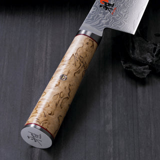 Miyabi Birchwood SG2 9-inch chef knife with a sharp blade and elegant birchwood handle, ideal for precise kitchen cutting tasks.