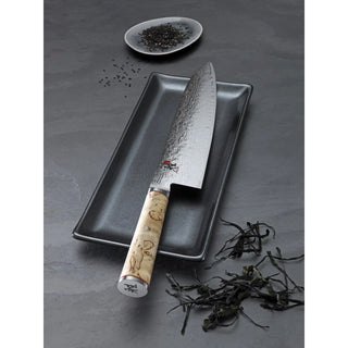 Miyabi Birchwood SG2 6-inch chef knife with a sleek blade and elegant wooden handle, ideal for precise kitchen cutting tasks.
