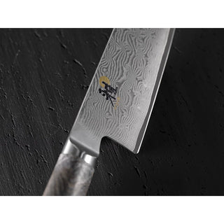Miyabi Black 5000 3.5-inch paring knife with black handle and sharp stainless steel blade for precise kitchen prep.