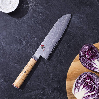 Miyabi Birchwood SG2 7-inch Santoku Knife with wooden handle and sharp stainless steel blade, ideal for precise kitchen slicing.
