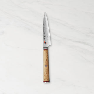 Miyabi Birchwood SG2 3.5-inch paring knife with a wooden handle and sharp stainless steel blade for precise kitchen cutting.