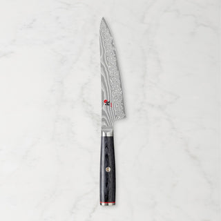 Miyabi Kaizen 5-inch prep knife with sharp stainless steel blade and ergonomic handle, ideal for precise kitchen prep tasks.